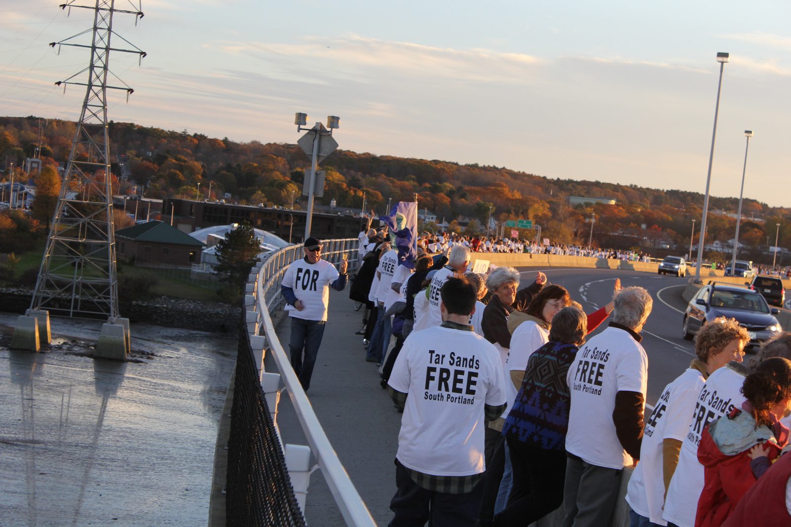 Marchers walking with signs against the Portland-Montreal pipeline reversal
