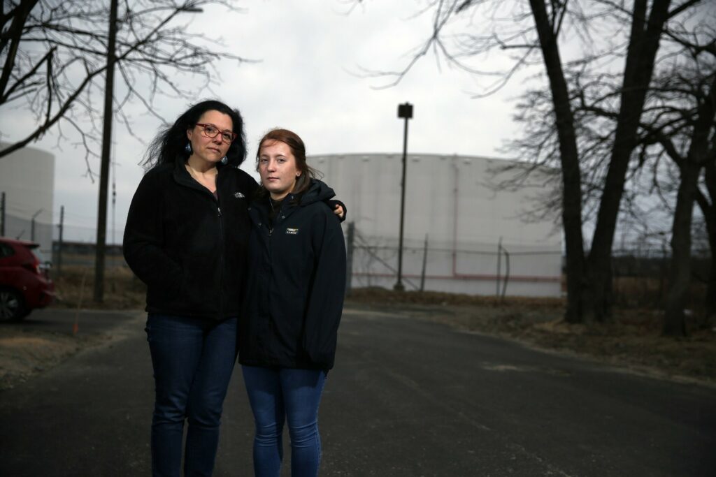 Kate Adamy and her daughter Ava Gleason on Elm Street in the Pleasantdale neighborhood, near the tank farms