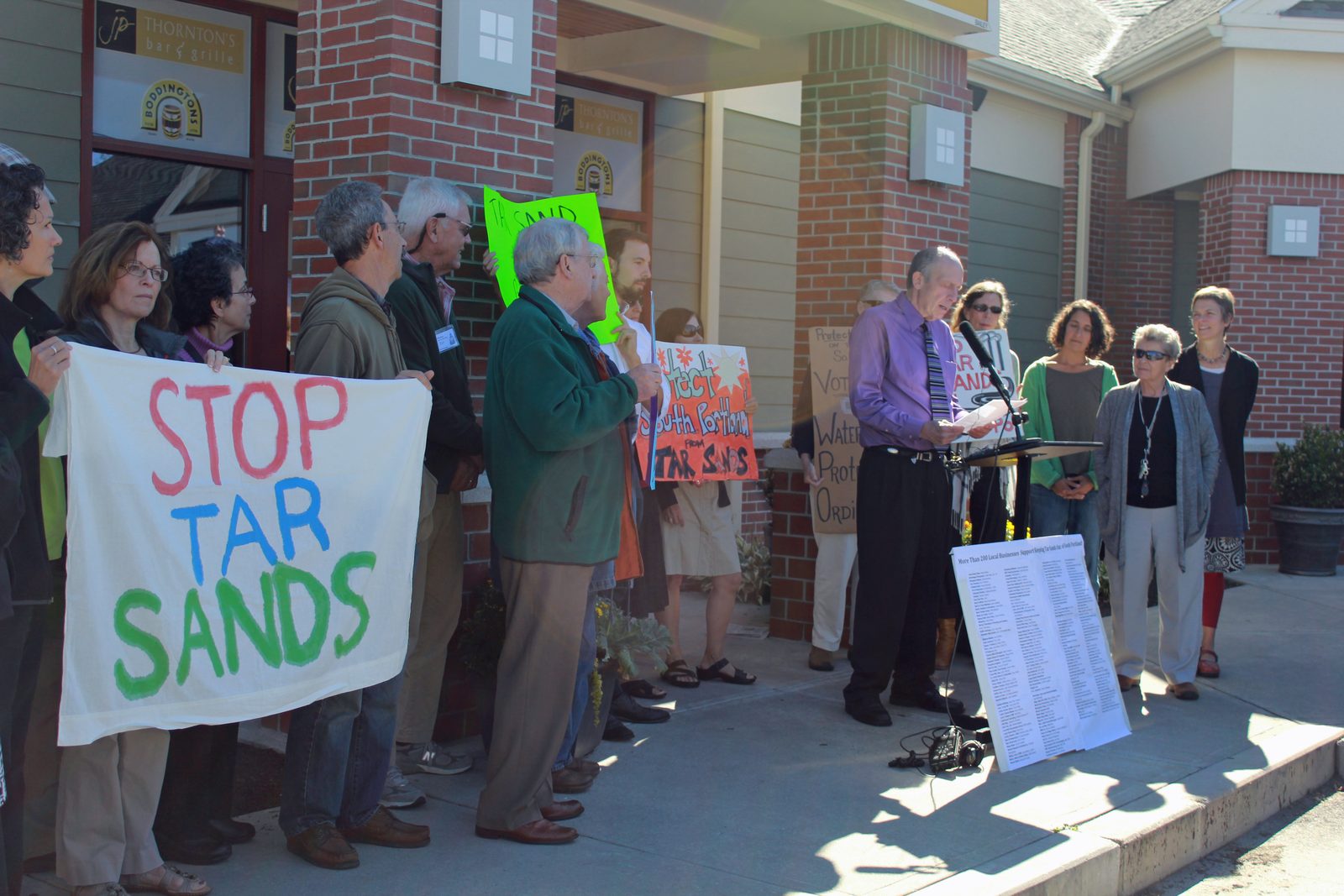 Protesters on the steps of South Portland City Hall holding Stop Tar Sands signs